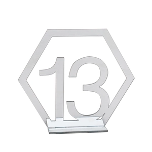 Detailed macro view of silver mirror acrylic hexagon wedding table number thirteen with stand