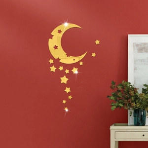 Detail of gold star and moon acrylic mirror wall stickers on a dark red wall decor