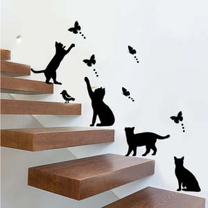 Detail of creative black cat and butterfly silhouette wall decals on a modern staircase