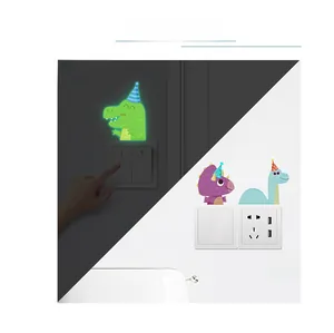 Luminous dinosaur wall stickers showing day and night glow effect on a light switch