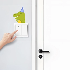 Close-up of a green cartoon dinosaur switch sticker in a modern bedroom setting