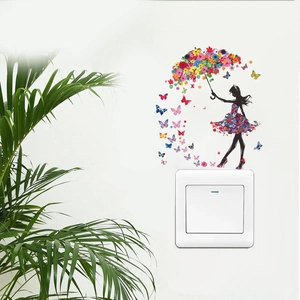 Detail of floral butterfly girl wall sticker applied above a white light switch panel