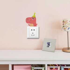 Detailed view of red cartoon dinosaur wall sticker with party hat on a pink bedroom wall