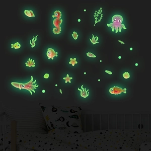 Luminous ocean-themed wall stickers showing seahorse and octopus glowing in a dark bedroom