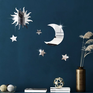 Detailed close-up of acrylic mirror sun, moon, and stars wall stickers on a textured blue wall
