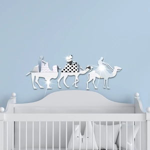 Detail of mirrored camel caravan wall stickers with geometric patterns on a blue wall