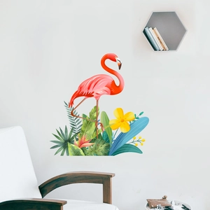 Detail of pink flamingo wall stickers with tropical green leaves and flowers in a living room