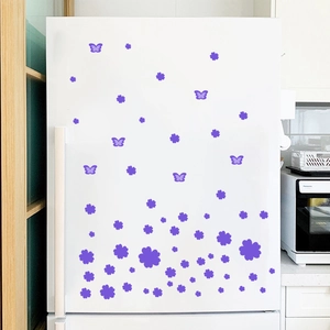 Detail of purple flower and butterfly wall stickers applied on a white refrigerator door