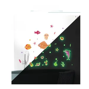 Glow-in-the-dark ocean wall decals showing daytime colors vs nighttime green fluorescent light