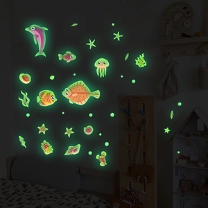 Glow-in-the-dark ocean life wall stickers showing green fluorescent sea animals in a dark room