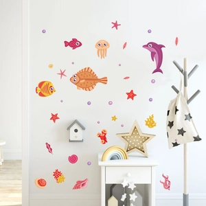 Detailed view of luminous ocean wall stickers featuring cartoon sea life on white bedroom walls