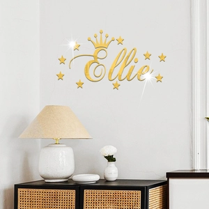 Detail of Ellie custom gold acrylic mirror wall sticker with crown and stars on white wall