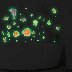 Glow in the dark ocean themed wall stickers featuring fish and jellyfish in bathroom