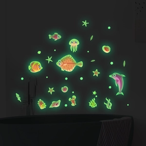Glow in the dark ocean life wall stickers featuring luminous fish and jellyfish in bathroom