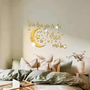 Detail of gold mirror acrylic moon and stars wall stickers with loving quote on bedroom wall