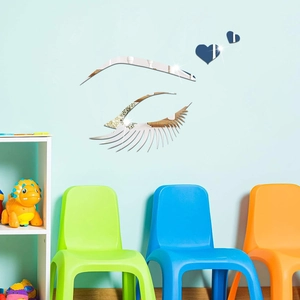 Silver mirror acrylic wall stickers featuring eyelash and heart shapes on a blue wall