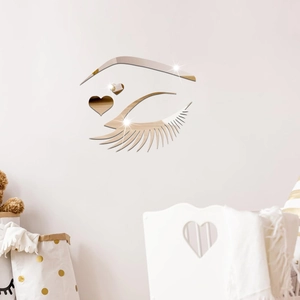 Detailed close-up of golden acrylic mirror wall stickers with eye and heart decorative design