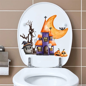Close-up of Halloween toilet lid sticker with moon, castle, and pumpkins on white cover