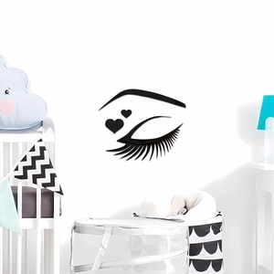 Detailed view of 3D black acrylic eyelash wall stickers in a modern nursery setting