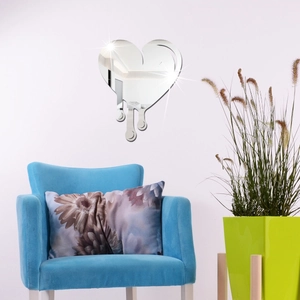Modern fluid dripping heart mirror wall sticker above a blue velvet armchair decoration