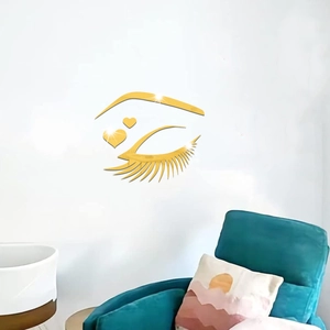 Detailed view of gold mirror acrylic eyelash wall stickers with heart accents in a room