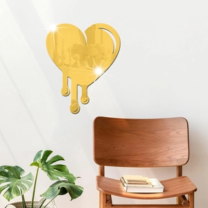 Glossy gold acrylic heart mirror wall sticker in a modern minimalist living room