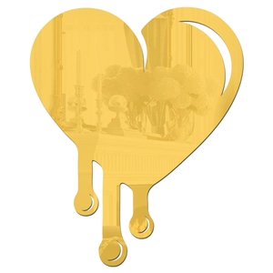 Close-up of golden melting heart mirror with a high-gloss metallic finish