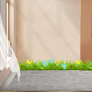 Detail view of decorative wall sticker featuring green grass, blue daisies and butterflies