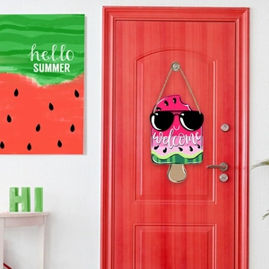 Detail of wooden watermelon popsicle welcome sign hanging on a vibrant red front door