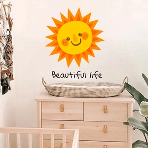 Close-up of sun wall decal with Beautiful Life text in a cozy Nordic nursery decor