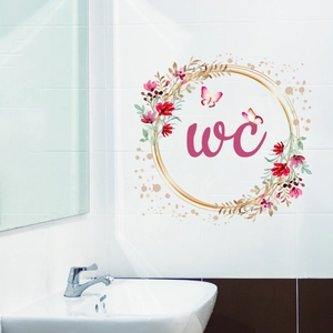 Detailed view of floral WC toilet wall sticker with pink butterflies and golden wreath