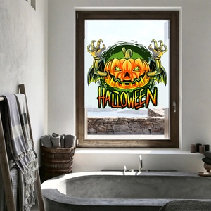 Detail view of a Halloween pumpkin window sticker with green wings on a bathroom window