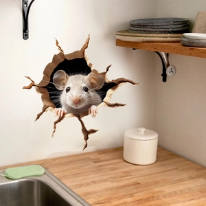 Close-up of 3D mouse wall sticker peeking from a broken hole in a kitchen setting