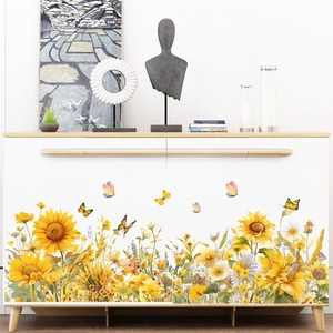 Watercolor sunflower and butterfly wall stickers applied on a white minimalist cabinet