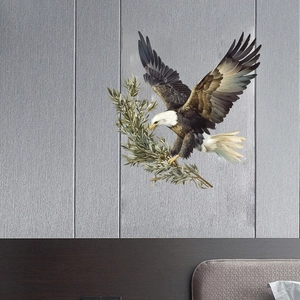 Detail view of watercolor eagle wall sticker with olive branch on a textured grey wall