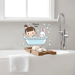 Detail of cartoon girl and rabbit wall sticker showing 'Showers Time' text on bathroom wall