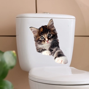 Detail view of 3D lifelike cat wall sticker applied on a white bathroom toilet tank