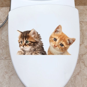 Detail showing two cute 3D cat stickers applied on a white toilet lid for bathroom decor