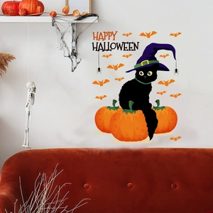 Detail of Halloween wall decals with black cat, pumpkin and bats on a white interior wall