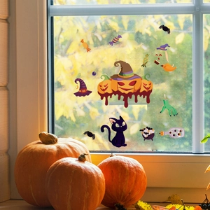 Close-up of Halloween window decals featuring pumpkins and cats on a glass surface