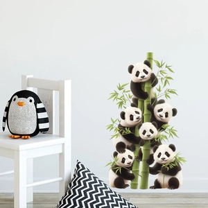Detail of cute panda wall stickers climbing bamboo on a white wall in a nursery room decor