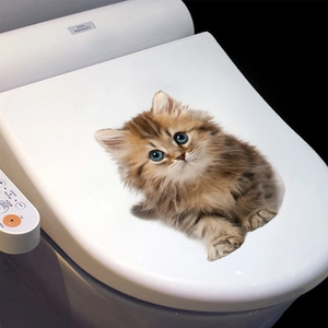 Detailed view of a realistic 3D orange tabby cat sticker applied on a white toilet lid