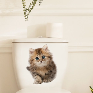 Macro shot of a 3D tabby cat wall sticker with blue eyes on a white toilet tank