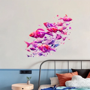 Detailed view of pink and purple geometric fish wall stickers in a modern bedroom setting