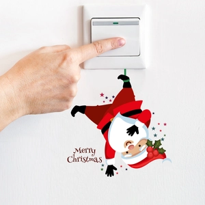 Detail showing Santa Claus wall sticker with Merry Christmas text around a light switch