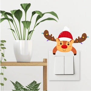 Detail of Christmas reindeer wall decal with Santa hat applied on a white light switch