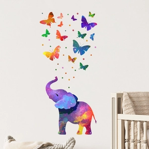 Artistic nebula watercolor elephant and butterfly wall stickers in a cozy nursery room