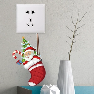 Detail of Christmas switch stickers featuring Santa and festive hanging decorations on wall