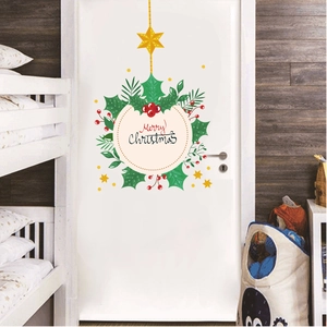Close-up of a festive Christmas tree wreath door sticker with Merry Christmas lettering