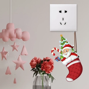Detailed view of Santa Claus in a Christmas stocking sticker next to a light switch
